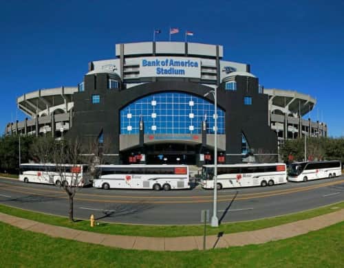 The Rose Coach fleet in font of the Bank of America Stadium